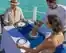 A hostess serving the premium drinks to a couple having private dinner near pool in Maldives resort